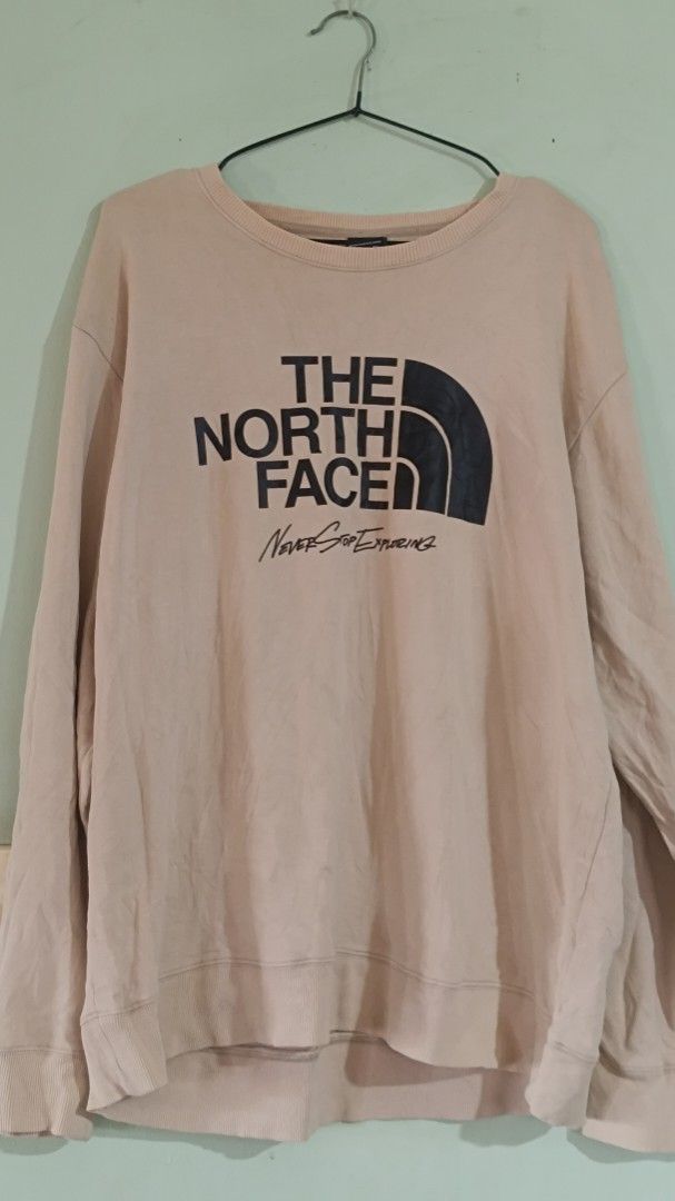 The North Face Crewneck Sweatshirt (Category: Coats, Jackets and Outerwear) located in Taguig. Submitted by redarmy21775000 (Listing ID 1463344371, Image 1). Description: - Brand: The North Face - Color: Light Pink - Style: Crewneck Sweatshirt - Features: Classic logo and 'Never Stop - need wash Exploring' text - Sizing: Unisex US/Asia XL/XXL - Ideal for: Casual wear and everyday adventures.
