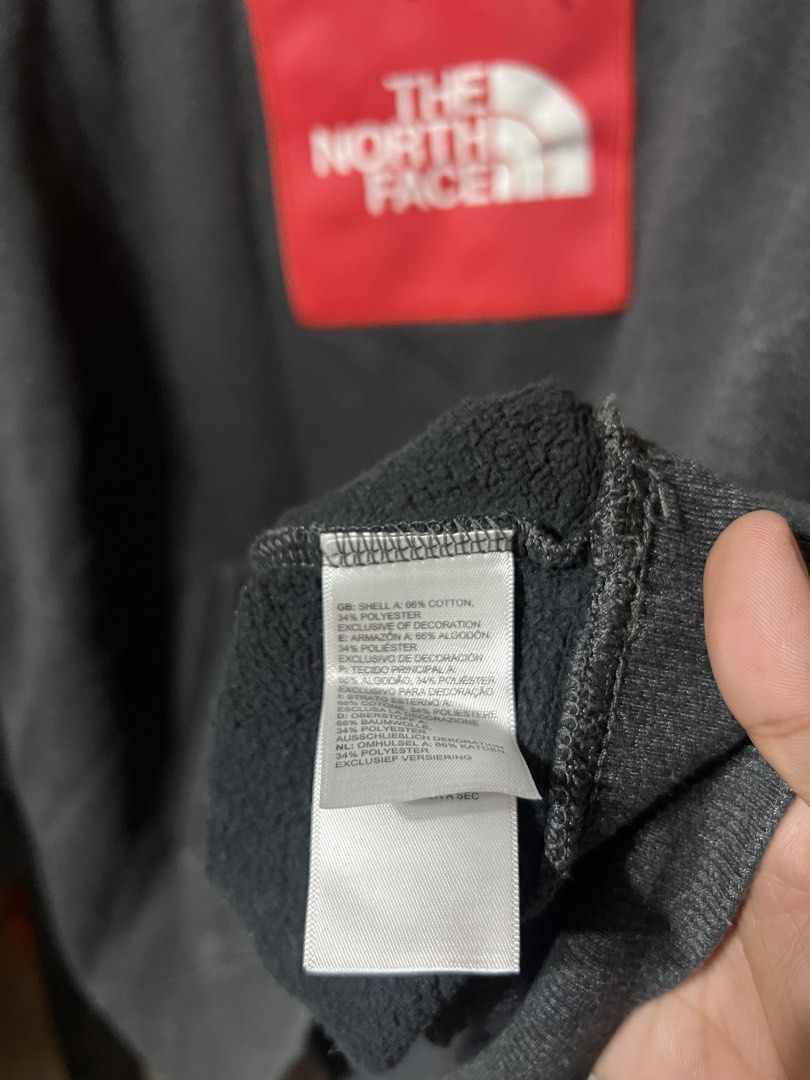The North Face Grey Cotton Polyester Sweatshirt (Category: Coats, Jackets and Outerwear) located in Butuan. Submitted by nikthrift. (Listing ID 1463334830, Image 3). Description: - Brand: The North Face - Color: Grey - Material: Cotton and Polyester blend - Features: Iconic red logo patch on chest - Style: Comfortable, casual, great for layering.
