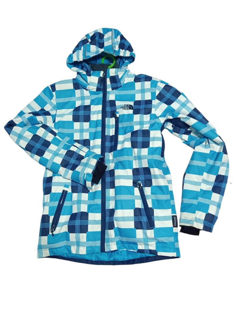 The North Face Plaid Ski Jacket (Category: Coats, Jackets and Outerwear) located in Baguio. Submitted by vyner_hues (Listing ID 1463404472, Image 2). Description: - The North Face plaid ski jacket - Color: Blue, white, and navy checkered pattern - Features: Hooded, zip-up front, zippered pockets - Warmth: Inner fleece lining - Ideal for: Skiing or staying cozy.