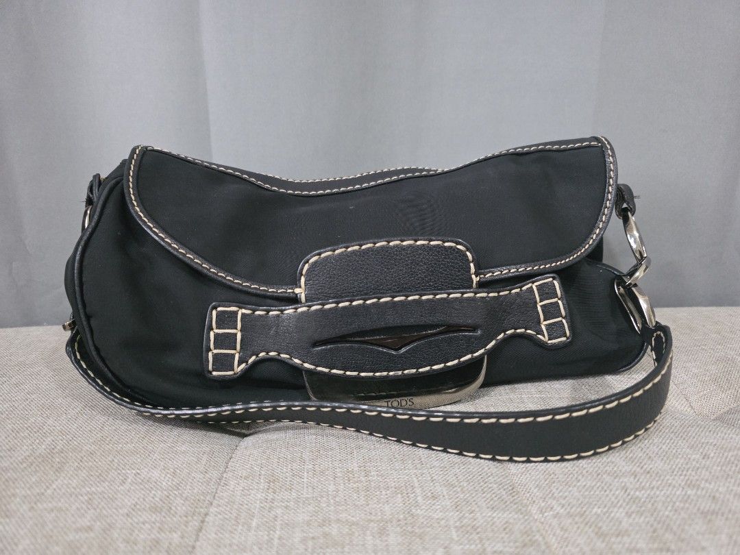 TOD'S Black Nylon Shoulder Bag with Leather Trim (Category: Luxury Bags & Wallets) located in Binan City. Submitted by karosellescloset (Listing ID 1463365896, Image 1). Description: - Brand: TOD'S - Material: Black Nylon with Leather Trim - Hardware: Silver - Features: Contrast stitching, adjustable strap - Condition: Shows some signs of wear on leather trim and strap - Ideal for: Everyday use.