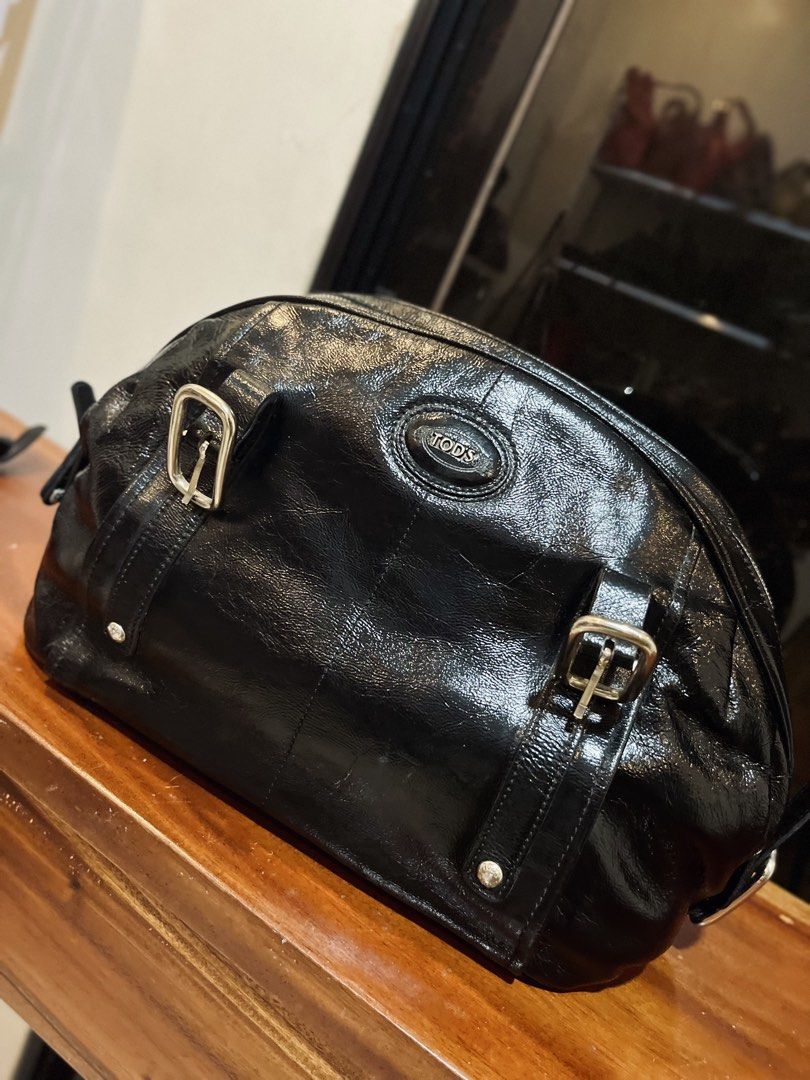 TOD'S Black Patent Leather Hobo Bag (Category: Luxury Bags & Wallets) located in Bacolod City. Submitted by vintage_vogue6100 (Listing ID 1463385916, Image 1). Description: - Authentic TOD'S hobo bag - Black patent leather - Silver hardware and buckle details - Zipper top closure - Classic, versatile design for everyday wear.