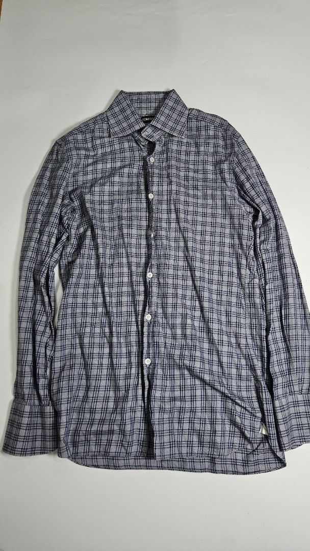 TOM FORD Plaid Button-Up Shirt (Category: Tshirts & Polo Shirts ) located in Alfonso. Submitted by jbcamet (Listing ID 1463522028, Image 1). Description: - Classic Tom Ford button-up shirt - Subtle navy and grey plaid pattern - Long sleeves with button cuffs - Made in Italy - Ideal for smart casual or formal wear - Check label for size details.