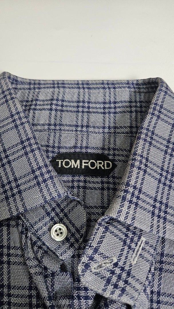 TOM FORD Plaid Button-Up Shirt (Category: Tshirts & Polo Shirts ) located in Alfonso. Submitted by jbcamet (Listing ID 1463522028, Image 2). Description: - Classic Tom Ford button-up shirt - Subtle navy and grey plaid pattern - Long sleeves with button cuffs - Made in Italy - Ideal for smart casual or formal wear - Check label for size details.