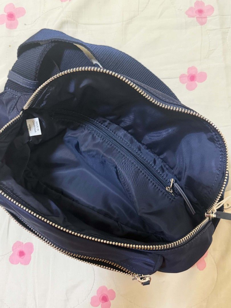 Tory Burch Navy Nylon Belt Bag (Category: Luxury Bags & Wallets) located in Pagadian. Submitted by patrickjames18 (Listing ID 1463472048, Image 2). Description: - Tory Burch Navy Blue Nylon Belt Bag - Silver Hardware and Zippers - Main Compartment with Interior Zip Pocket - Front Zip Pocket - Adjustable Strap - Made in Cambodia - Ideal for Everyday Use or Travel.