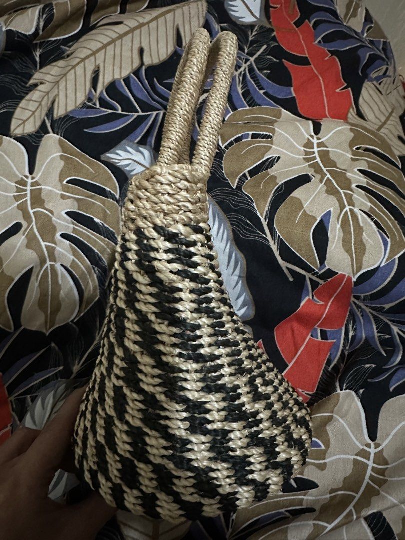 Two - Toned Abaca Bag (Category: Tote Bags) located in Angeles City. Submitted by iybebng (Listing ID 1463546458, Image 2). Description: - Cute woven tote bag - Natural straw material - Black and tan geometric pattern - Woven straw handles - Tie top closure - Ideal for beach days or casual outings - Spacious for essentials.