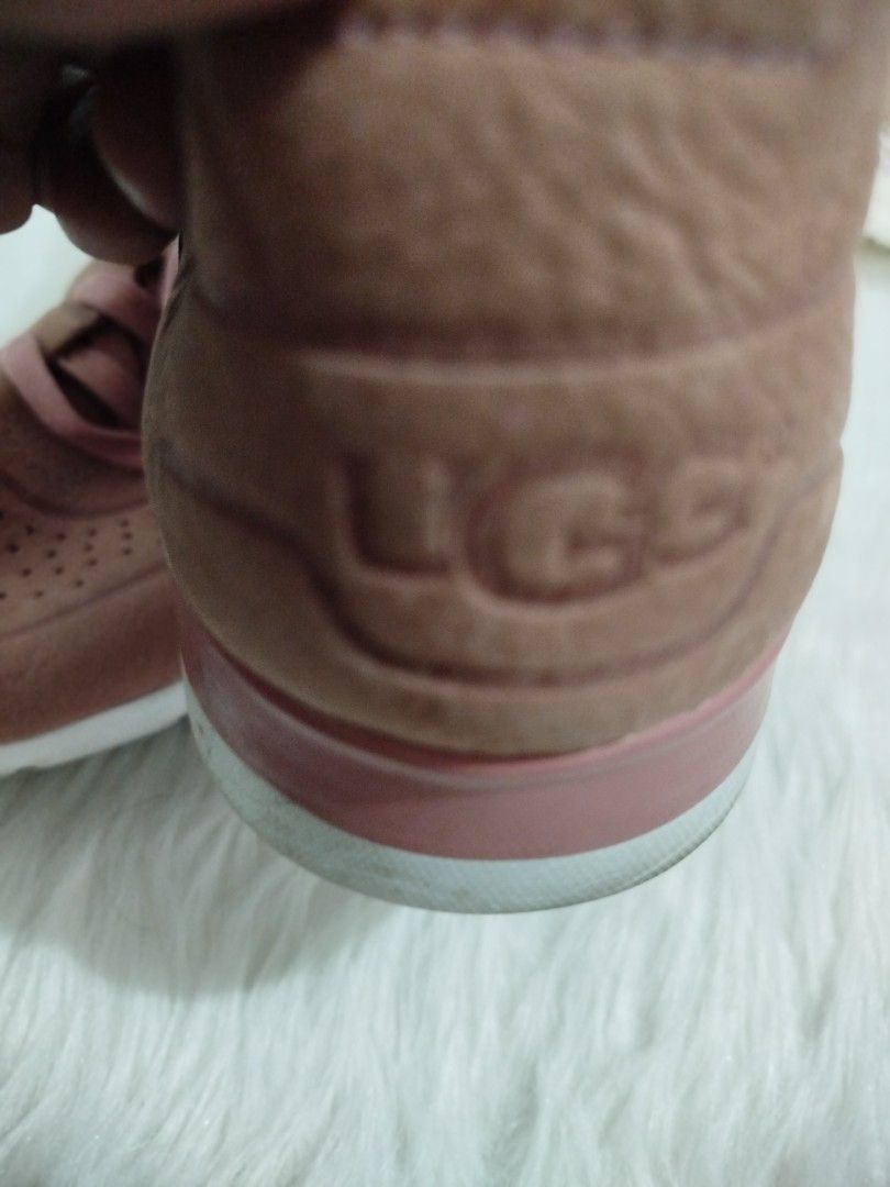 UGG Pink Leather Perforated Sneakers (Category: Sneakers) located in Quezon City. Submitted by plus4lessshop (Listing ID 1463358789, Image 2). Description: - Pink UGG sneakers - Genuine leather with all-over perforations - Classic lace-up closure - UGG logo embossed on heel and tag - White sole with a pink accent detail.