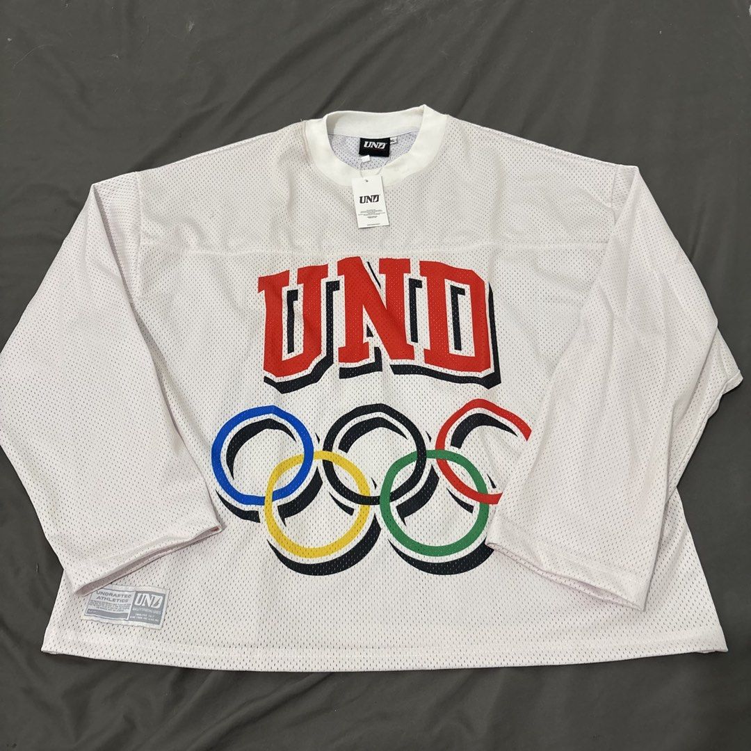 Undrafted jersey longsleeves (Category: Activewear) located in Makati City. Submitted by sseurekiii (Listing ID 1463397019, Image 1). Description: - Brand: UNDFTD - Item: Long Sleeve Jersey - Color: White - Material: Mesh - Size: XL - Features: UND logo and Olympic rings graphic - Never been used .