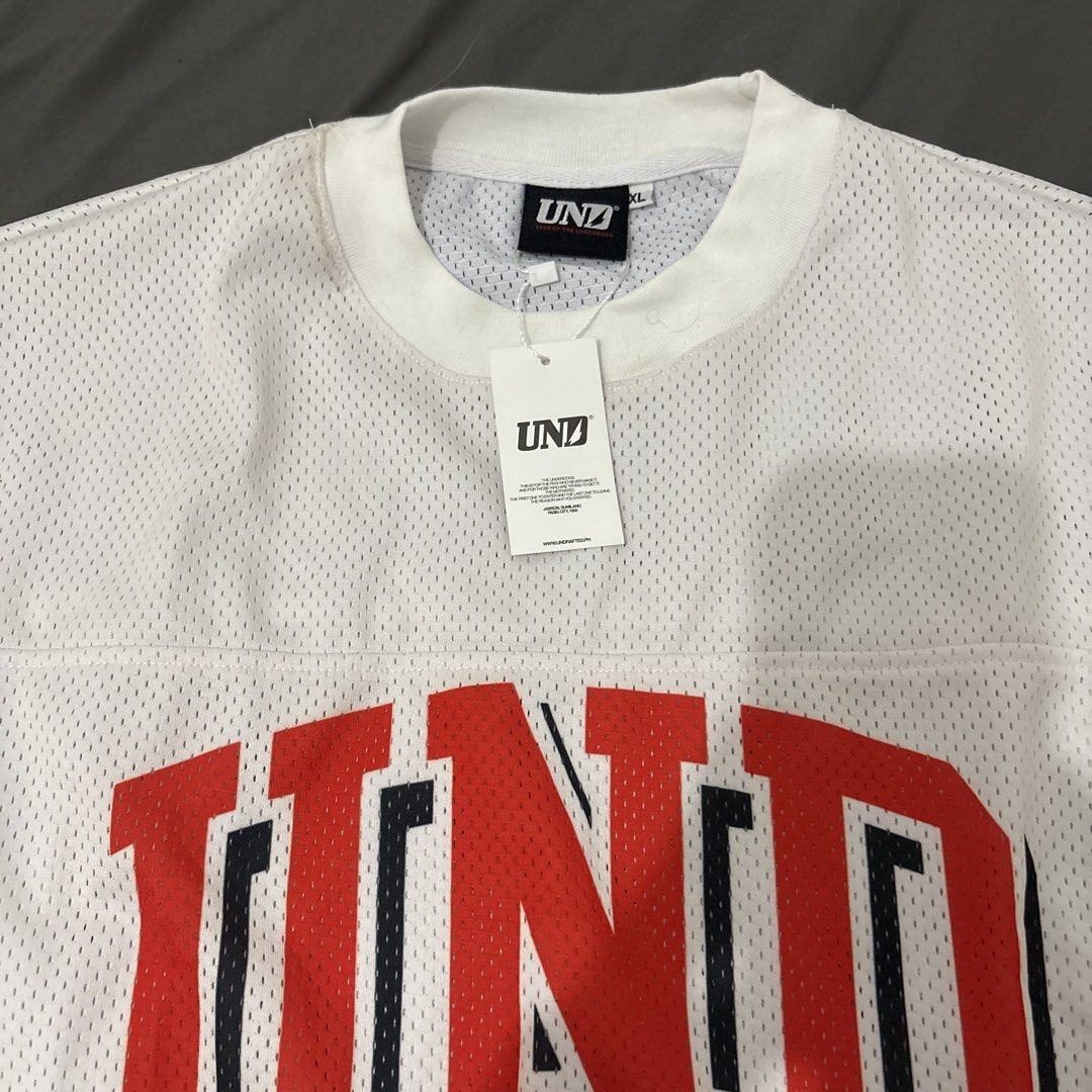 Undrafted jersey longsleeves (Category: Activewear) located in Makati City. Submitted by sseurekiii (Listing ID 1463397019, Image 2). Description: - Brand: UNDFTD - Item: Long Sleeve Jersey - Color: White - Material: Mesh - Size: XL - Features: UND logo and Olympic rings graphic - Never been used .