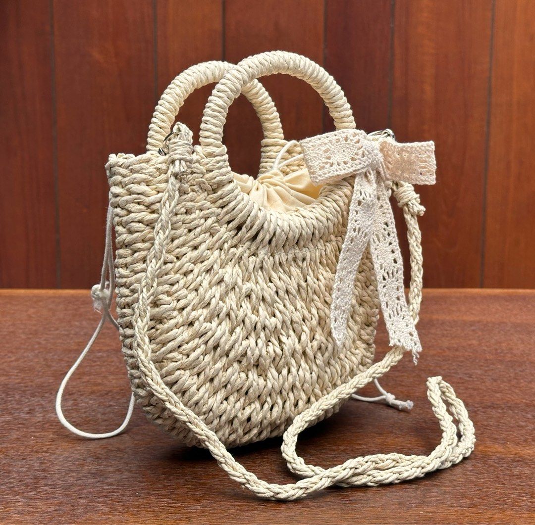Unused Cute woven straw bag (Category: Cross-body Bags) located in Bulacan. Submitted by thriftbagcollections (Listing ID 1463396509, Image 3). Description: Unused Cute woven straw handbag with braided handles and a lovely crochet ribbon detail. Comes with a long strap, perfect for casual days, summer outfits, and beach dates.Approx:H-6.5”W-8.2”.