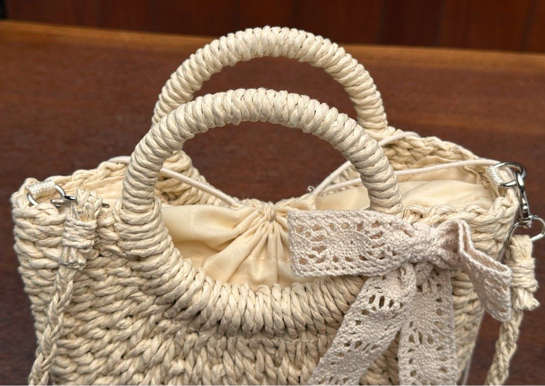 Unused Cute woven straw bag (Category: Cross-body Bags) located in Bulacan. Submitted by thriftbagcollections (Listing ID 1463396509, Image 2). Description: Unused Cute woven straw handbag with braided handles and a lovely crochet ribbon detail. Comes with a long strap, perfect for casual days, summer outfits, and beach dates.Approx:H-6.5”W-8.2”.
