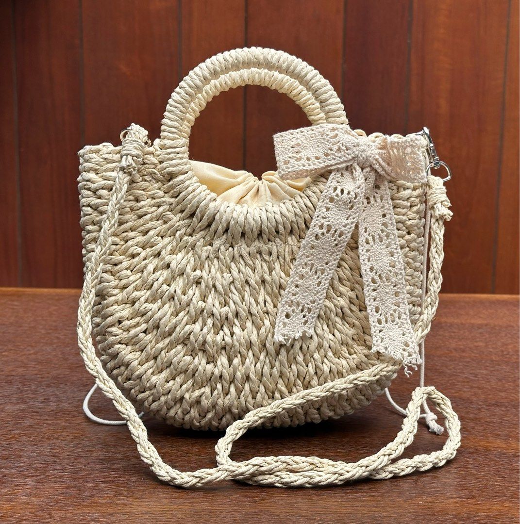 Unused Cute woven straw bag (Category: Cross-body Bags) located in Bulacan. Submitted by thriftbagcollections (Listing ID 1463396509, Image 1). Description: Unused Cute woven straw handbag with braided handles and a lovely crochet ribbon detail. Comes with a long strap, perfect for casual days, summer outfits, and beach dates.Approx:H-6.5”W-8.2”.