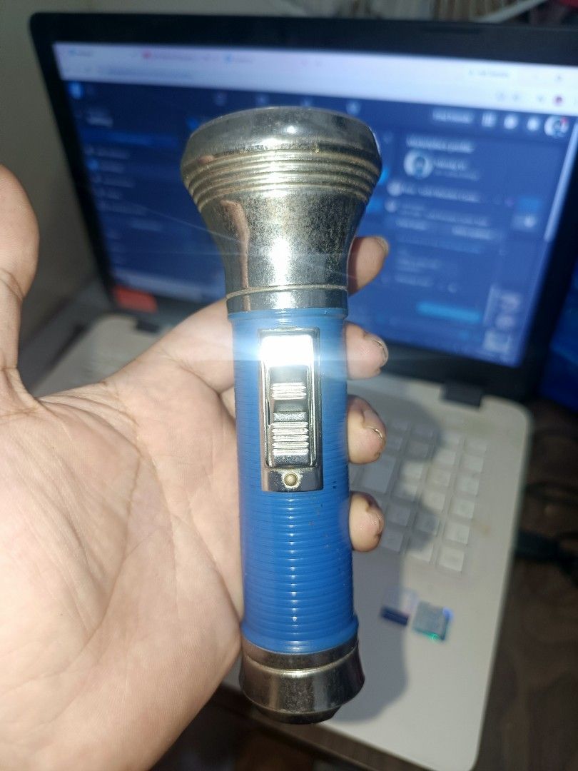 Vintage Classic Chrome Head Flashlight (Blue Ribbed Body) – Tested & Working (Category: Travel Essentials & Accessories) located in Cebu City. Submitted by turuuru8992423 (Listing ID 1463351968, Image 1). Description: Vintage Classic Chrome Head Flashlight (Blue Ribbed Body) – Tested & Working Description: Classic vintage-style handheld flashlight with a shiny chrome reflector head and blue ribbed body. Features a traditional slider switch and wa