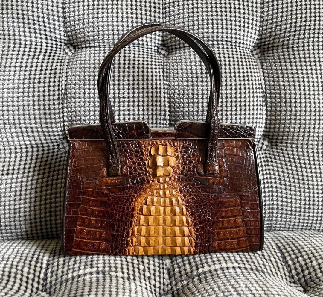 Vintage Crocodile skin clutch (Category: Clutches) located in Bulacan. Submitted by thriftbagcollections (Listing ID 1463458687, Image 1). Description: Vintage Crocodile skin clutch,good condition! Approx:H-5.6”W-8.5”D-2.5” handle6.5”.