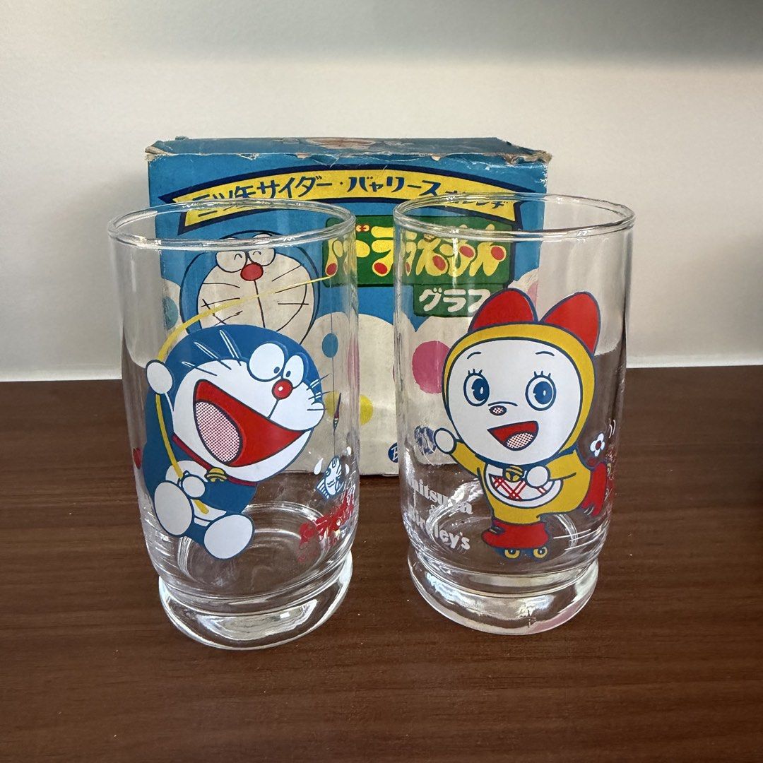 Vintage drinking glasses featuring Doraemon and Dorami-chan (Category: Vintage Collectibles) located in Bulacan. Submitted by prelovedetc (Listing ID 1463326651, Image 1). Description: This is a set of two 1980s vintage glasses Japanese promotional drinking glasses featuring Doraemon and Dorami-chan. They have a retro Showa-era feel and are recommended as collector's items. Brand new and comes with the original old box..