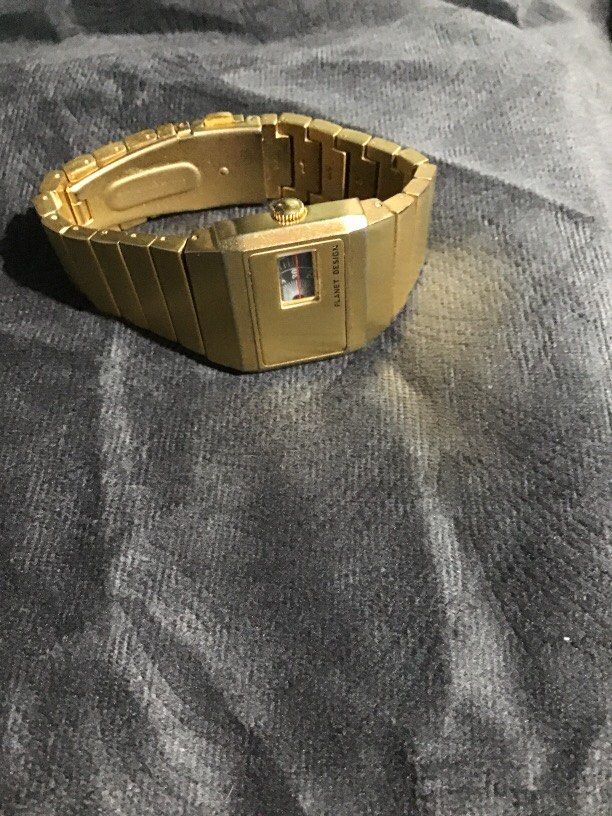 Vintage gold-tone Planet Design watch (Category: Luxury Watches) located in Baguio. Submitted by agozun61 (Listing ID 1463553487, Image 3). Description: This is a vintage gold tone Planet Design jump hour wrist watch featuring a rectangular case with a small rotating disc time display window..