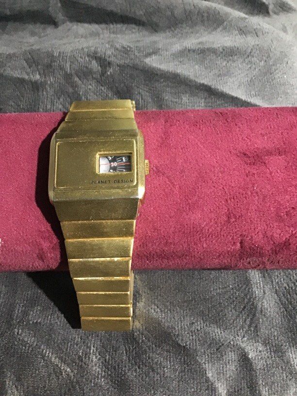 Vintage gold-tone Planet Design watch (Category: Luxury Watches) located in Baguio. Submitted by agozun61 (Listing ID 1463553487, Image 1). Description: This is a vintage gold tone Planet Design jump hour wrist watch featuring a rectangular case with a small rotating disc time display window..