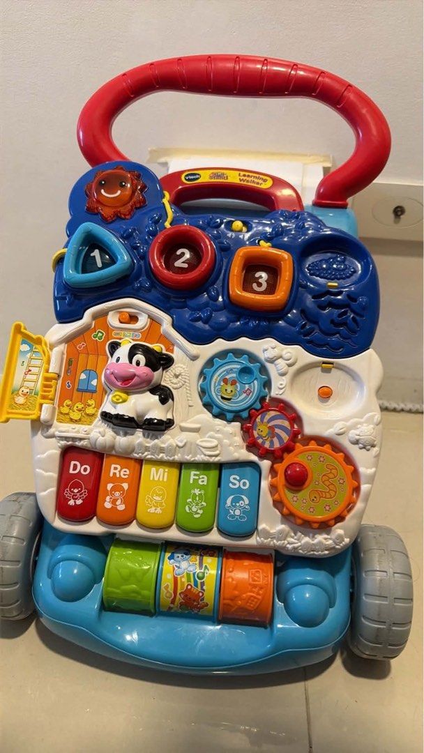 VTech Learning Walker Toy (Category: Infant Playtime) located in Mandaluyong City. Submitted by prelovedmanila18 (Listing ID 1463424803, Image 2). Description: - VTech Learning Walker - Interactive buttons and activities (piano keys, gears, shapes) - Promotes motor skill development and learning - Sturdy red handle for pushing - Ideal for babies learning to walk.