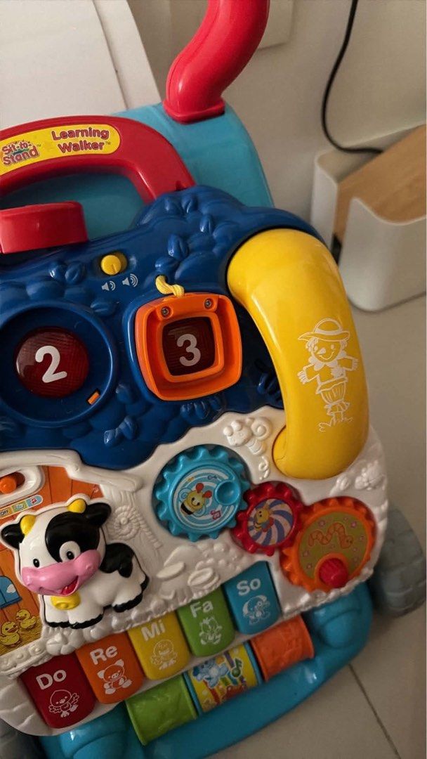 VTech Learning Walker Toy (Category: Infant Playtime) located in Mandaluyong City. Submitted by prelovedmanila18 (Listing ID 1463424803, Image 3). Description: - VTech Learning Walker - Interactive buttons and activities (piano keys, gears, shapes) - Promotes motor skill development and learning - Sturdy red handle for pushing - Ideal for babies learning to walk.