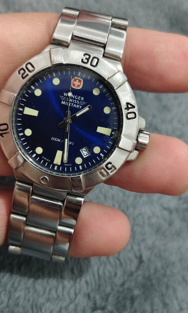 Wenger Swiss Military (Category: Men's Watches) located in Cebu City. Submitted by aceoftime (Listing ID 1463524158, Image 1). Description: In good working condition Swiss Made Analog quartz with date display Blue dial in stainless steel case & bracelet 200m water resist Watch only Our Guarantee: 💯 Authentic All watches are checked by our experienced technician to ensure good functionality Please manage your expectations since these are preloved
