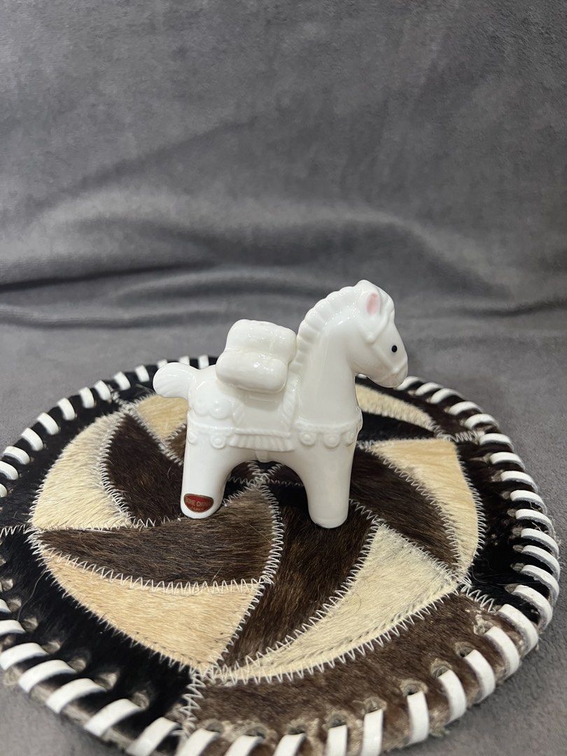 White Ceramic Horse Figurine with Saddle (Category: Other Home Decor) located in Las Pinas. Submitted by maple0305 (Listing ID 1463360570, Image 2). Description: - Adorable white ceramic horse figurine - Approximately 4 inches tall - Detailed saddle and reins - Cute pink blush on ears - Black dot eyes - Green felt pads on the bottom for protection - Ideal for display or as a charming decorative piece.