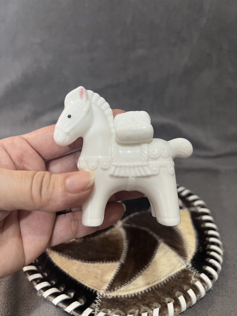 White Ceramic Horse Figurine with Saddle (Category: Other Home Decor) located in Las Pinas. Submitted by maple0305 (Listing ID 1463360570, Image 3). Description: - Adorable white ceramic horse figurine - Approximately 4 inches tall - Detailed saddle and reins - Cute pink blush on ears - Black dot eyes - Green felt pads on the bottom for protection - Ideal for display or as a charming decorative piece.