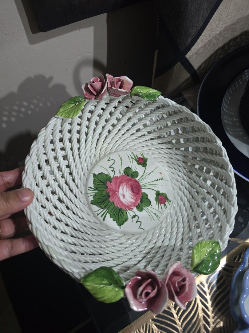 White Ceramic Woven Basket with Pink Roses (Category: Storage Boxes & Baskets) located in Santa Rosa. Submitted by yannagil (Listing ID 1463495911, Image 1). Description: - Lovely white ceramic basket - Features a beautiful woven texture all around - Decorated with delicate pink roses and green leaves - Centerpiece showcases a hand-painted rose design - Ideal for organizing small items or as an elegant decorative accent - Adds a charming touch to