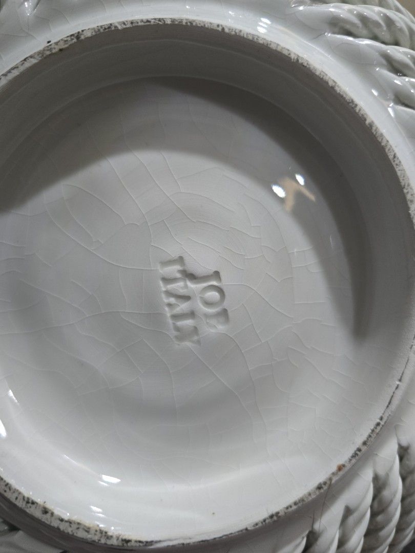 White Ceramic Woven Basket with Pink Roses (Category: Storage Boxes & Baskets) located in Santa Rosa. Submitted by yannagil (Listing ID 1463495911, Image 3). Description: - Lovely white ceramic basket - Features a beautiful woven texture all around - Decorated with delicate pink roses and green leaves - Centerpiece showcases a hand-painted rose design - Ideal for organizing small items or as an elegant decorative accent - Adds a charming touch to