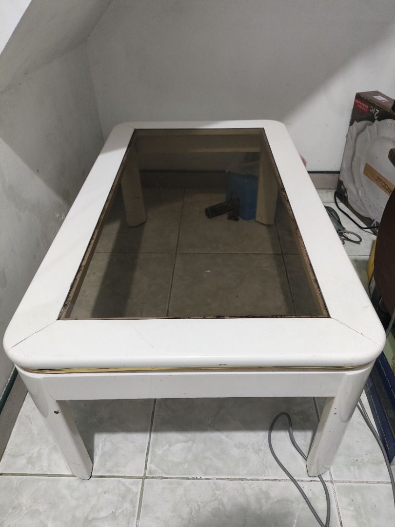 White Coffee Table with Glass Top (Category: Tables & Sets) located in Caloocan City. Submitted by cerberius15 (Listing ID 1463397903, Image 2). Description: - Rectangular coffee table - White frame with rounded edges - Smoked glass top, sits flush with frame - Four sturdy legs - Generous surface area for drinks and decor - Ideal for living room use.