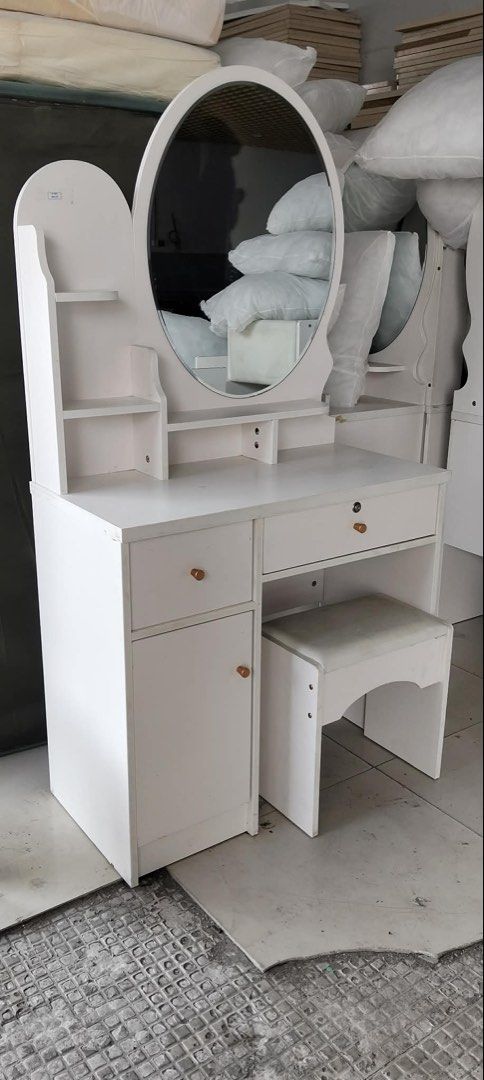 White Dressing Table with Mirror and Stool (Category: Tables & Sets) located in Manila. Submitted by marquezpa52205 (Listing ID 1463331966, Image 1). Description: - Complete white dressing table set - Includes matching mirror - Comes with a comfortable cushioned stool - Ample storage with drawers and a cabinet - Shelves above the table for displaying decor - Simple and functional design.