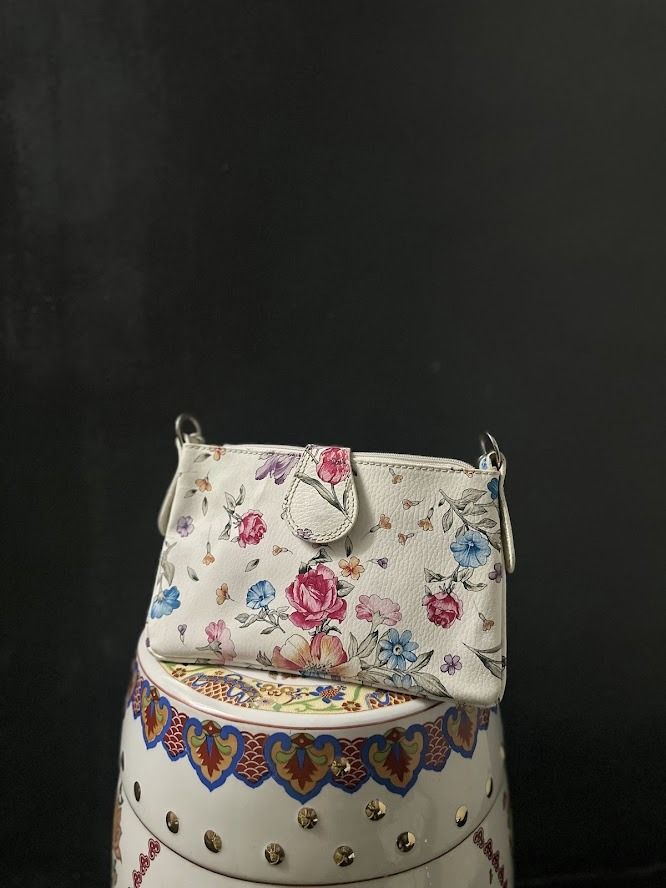 White Floral Shoulder Bag with Silver Buckle (Category: Shoulder Bags) located in Caloocan City. Submitted by zealgem_d3432f (Listing ID 1463529556, Image 2). Description: - Cute white shoulder bag - Vibrant floral print - Silver buckle closure on front flap - Small size, ideal for essentials - Adjustable strap - Small charm attached to zipper - Perfect for casual day outs Please feel free to message me if there are any inquiries or requests for 