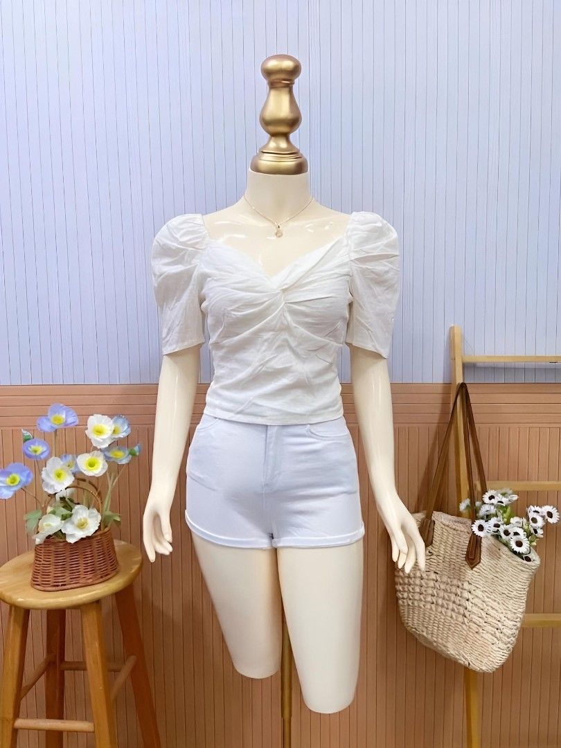 White FrontTwist Puff Sleeve Top (Category: Blouses) located in Roxas City. Submitted by blairnstyle (Listing ID 1463401917, Image 1). Description: ​Color: White ​Neckline: V-neck with a soft, structured plunge ​Sleeves: puff sleeves (gathered at the shoulders with gentle volume) ​Front Detail: Twisted knot or gathered drapery across the bust/chest area, creating a flattering, textured bodice.