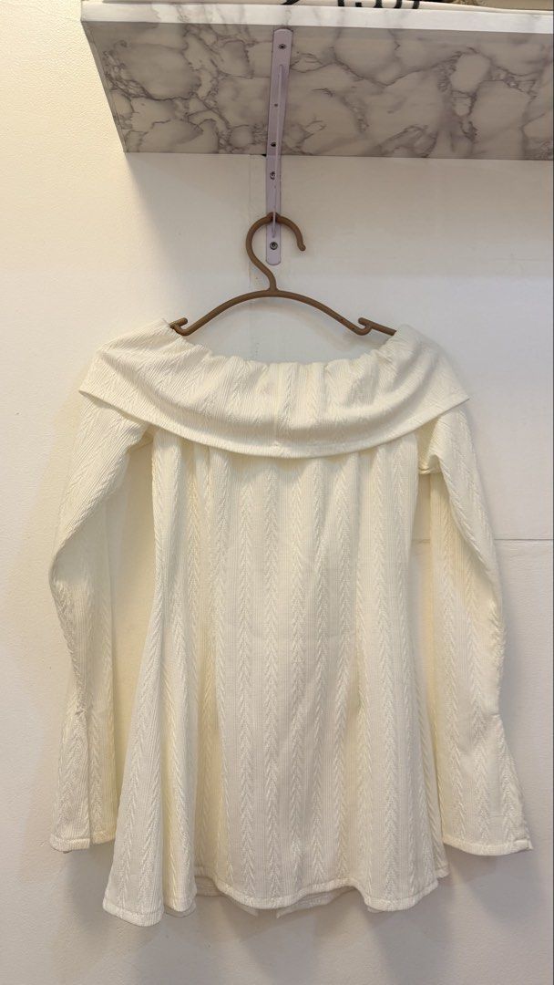 White Off-Shoulder Textured Top with Buttons (Category: Blouses) located in Angeles City. Submitted by hooni_park (Listing ID 1463481180, Image 2). Description: - White off-shoulder top - Textured fabric with vertical stripe pattern - Three buttons down the front - Long sleeves with flared cuffs - Perfect for dressing up or down - Easy to style for any outfit.