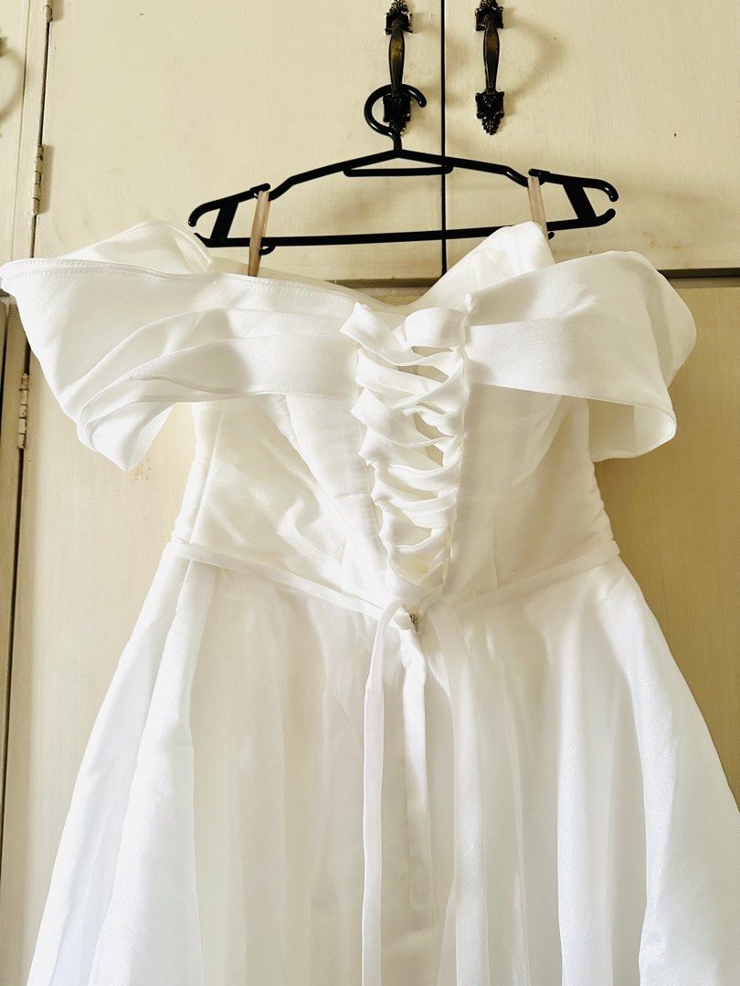White Off-Shoulder Wedding Dress with Veil (Category: Evening dresses & gowns) located in Dasmarinas. Submitted by chocnutpie (Listing ID 1463555642, Image 2). Description: - With asymmetric off-shoulder sleeves for style - Lace-up back for a custom, adjustable fit - Perfect for civil wedding / reception dress - Free size (freely adjustable from chest to waist with corset at the back) - Ankle-length for 5’3” height - With included ribbon accessor