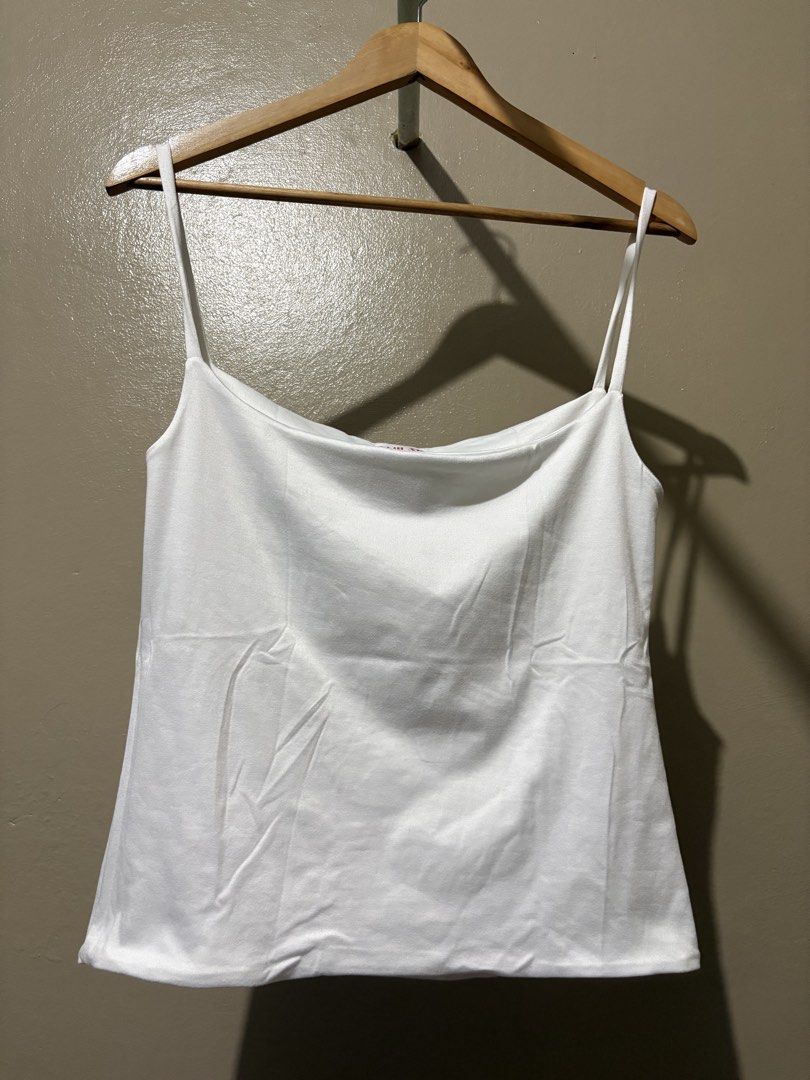 White Spaghetti Strap Tank Top (Category: Sleeveless) located in Manila. Submitted by stella_mari27 (Listing ID 1463454075, Image 1). Description: - Basic white tank top - Thin spaghetti straps - Square neckline - Simple and versatile - Great for layering or wearing on its own - Easy to match with any outfit - Perfect for casual wear.