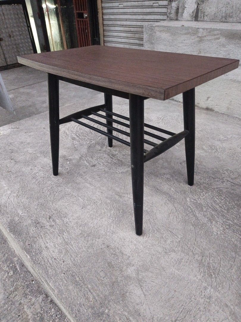 Wooden Coffee Table with Black Legs (Category: Tables & Sets) located in Valenzuela. Submitted by kendra071914 (Listing ID 1463467206, Image 3). Description: - Rectangular coffee table - Wood-grain top for a natural look - Sturdy black tapered legs - Convenient lower shelf for extra storage - Dimensions: Height 47cm, Length 60cm, Width 38cm - Ideal for living rooms or as a decorative accent piece.