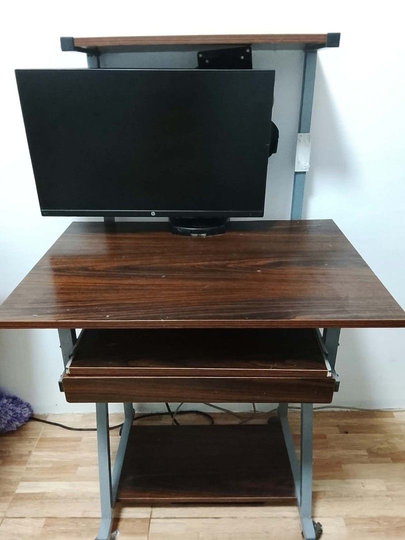 Wooden Computer Desk with printer Stand and Keyboard Tray (Category: Tables & Sets) located in Pasig City. Submitted by merl01 (Listing ID 1463531241, Image 3). Description: COMPUTER TABLE WITH PRINTER STAND & DRAWER Selling Price: ₱1,200 (slightly negotiable sa sure buyer) with a slide-out keyboard tray (positioned above the drawer) Built-in top printer stand With wheels for easy mobility Heavy, sturdy, and highly durable High quality wood Can b