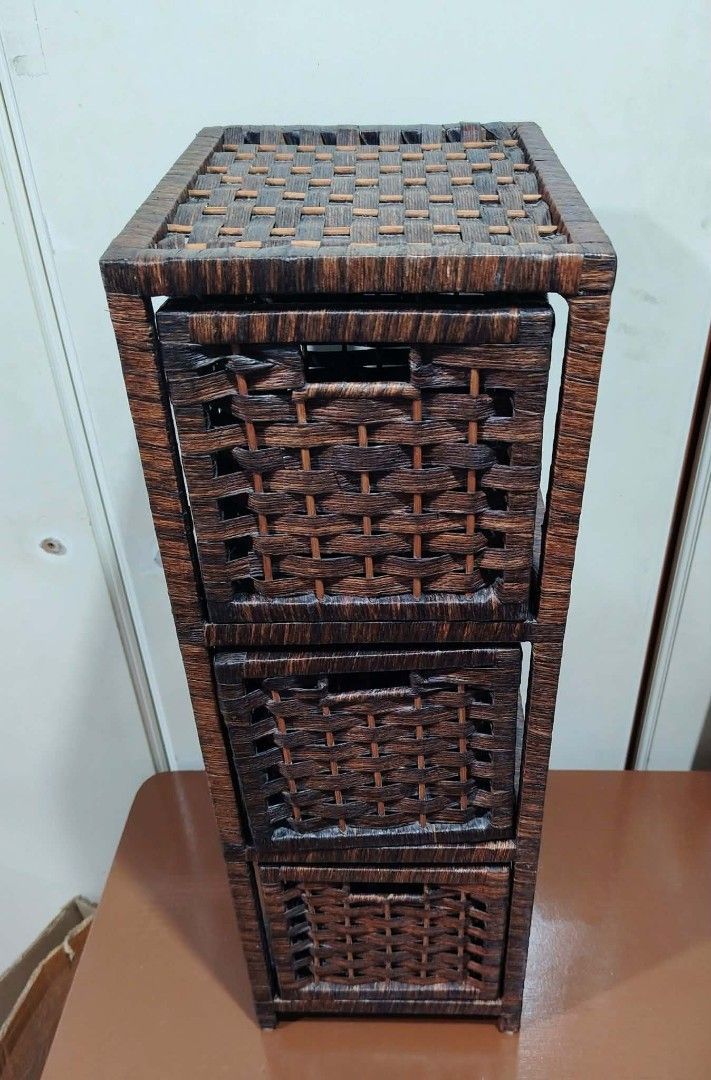 Woven 3-Drawer Storage Cabinet Organizer (Category: Shelves, Cabinets & Racks) located in Caloocan City. Submitted by sydney08.owl (Listing ID 1463459047, Image 2). Description: - Tall woven storage cabinet in dark brown. - Made of durable rattan or similar material. - Features three spacious drawers for organizing small items. - Compact dimensions: L-9.75" x W-12.5" x H-28". - Ideal for maximizing space in tight areas..