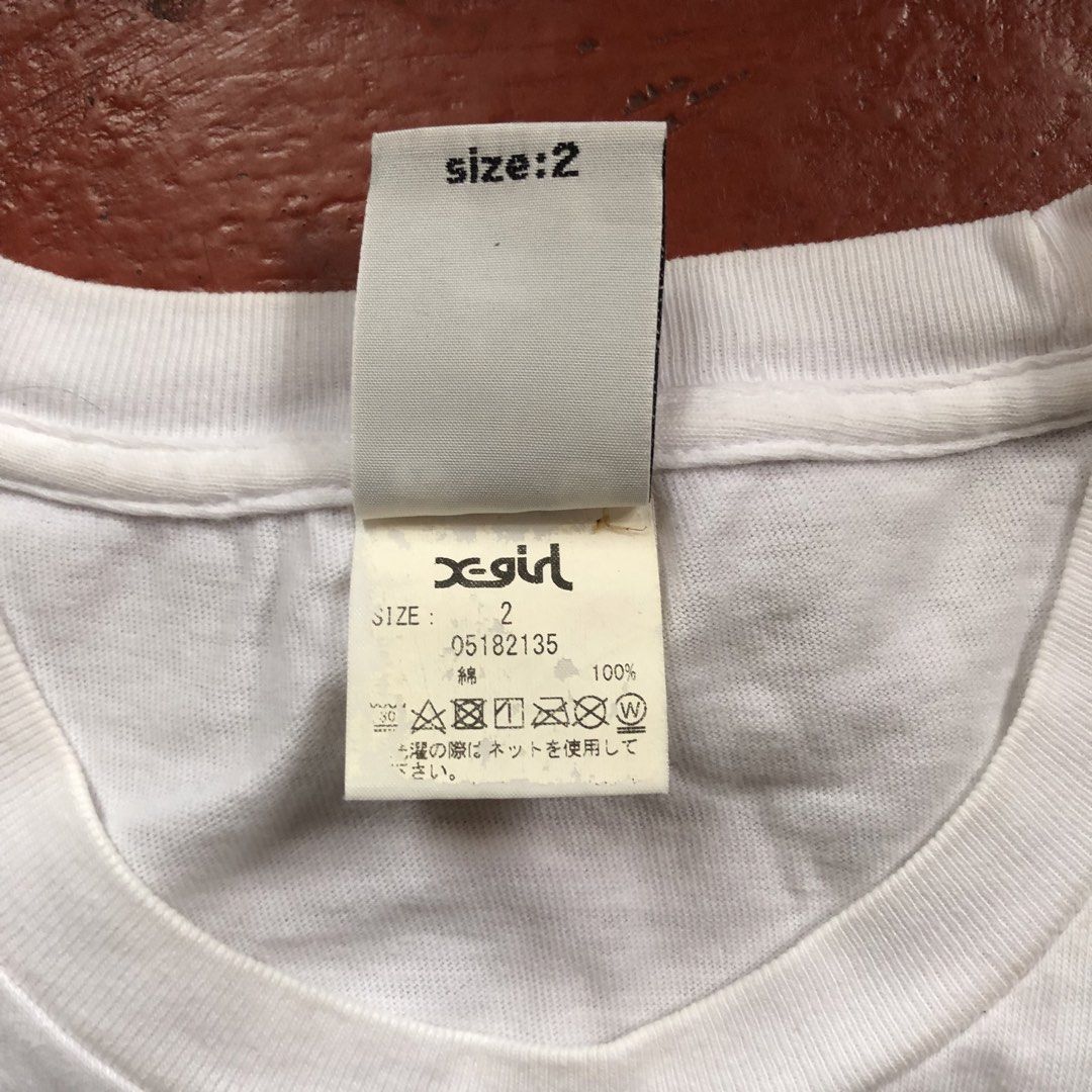 X-Girl White Tee (Category: Tshirts & Polo Shirts ) located in Manila. Submitted by dopethrift.cat (Listing ID 1463396856, Image 3). Description: Dimension: Inches Width: 20" Length: 27" Sleeve: 8" mop: gcash ship: lalamove or jnt - White X-Girl t-shirt - Features embroidered X-Girl logo on the front - Tagged size 2 - Made of 100% cotton - Perfect basic piece for any outfit.