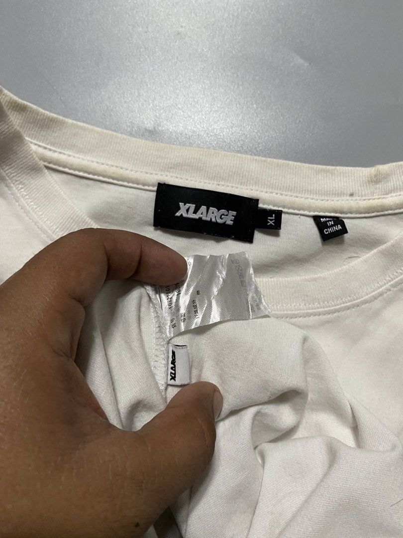 XLARGE White Praying Hands Graphic T-Shirt (Category: Tshirts & Polo Shirts ) located in Silang. Submitted by kenneth_ukays (Listing ID 1463343227, Image 3). Description: - XLARGE White T-Shirt - Size: XL - Features a cool praying hands graphic - Includes a gold chain detail - XLARGE logo present - Made in China - Ideal for casual wear.