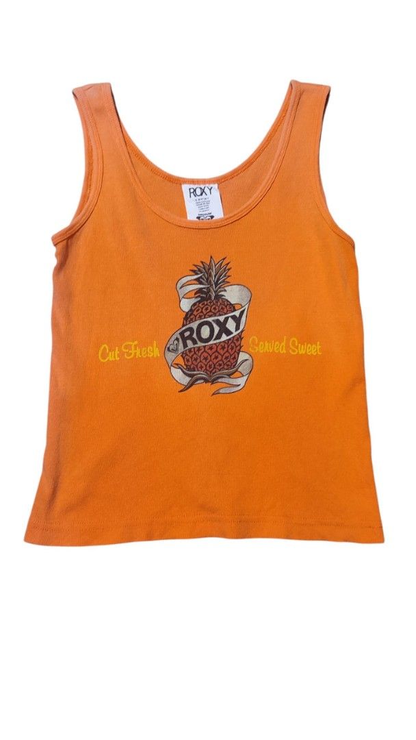 Y2k Roxy Orange Pineapple Graphic Tank Top (Category: Sleeveless) located in Zamboanga. Submitted by archivist_ (Listing ID 1463399459, Image 1). Description: - Cute orange Roxy tank top - Features a fun pineapple graphic - Roxy logo and 'Cut Fresh Served Sweet' text - Ribbed texture - Ideal for casual wear or beach days Issue: Faded.