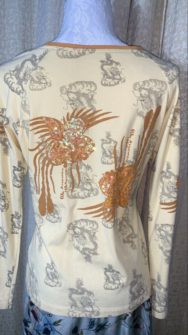 Yellow Dragon & Phoenix Sequin Long Sleeve Top (Category: Longsleeves) located in Dagupan City. Submitted by sj_styles0910. (Listing ID 1463533407, Image 3). Description: - Creamy yellow long-sleeved top - All-over print of dragons and clouds - Large sequined phoenix design on front and back - Sequins in a mix of orange and pink - Crew neckline - Perfect statement piece.