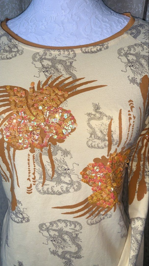 Yellow Dragon & Phoenix Sequin Long Sleeve Top (Category: Longsleeves) located in Dagupan City. Submitted by sj_styles0910. (Listing ID 1463533407, Image 2). Description: - Creamy yellow long-sleeved top - All-over print of dragons and clouds - Large sequined phoenix design on front and back - Sequins in a mix of orange and pink - Crew neckline - Perfect statement piece.