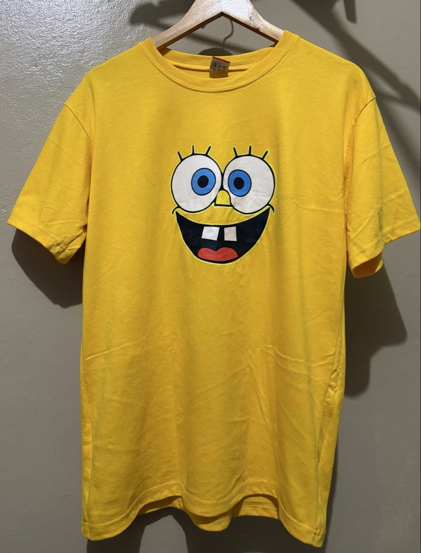 Yellow Spongebob Squarepants Graphic T-shirt (Category: Tshirts & Polo Shirts ) located in Manila. Submitted by stella_mari27 (Listing ID 1463434090, Image 1). Description: - Bright yellow t-shirt with a fun Spongebob graphic - Short sleeves and classic crew neck design - Made from comfortable fabric for everyday wear - Easy to style with jeans or shorts - Ideal for Spongebob fans and casual outings.