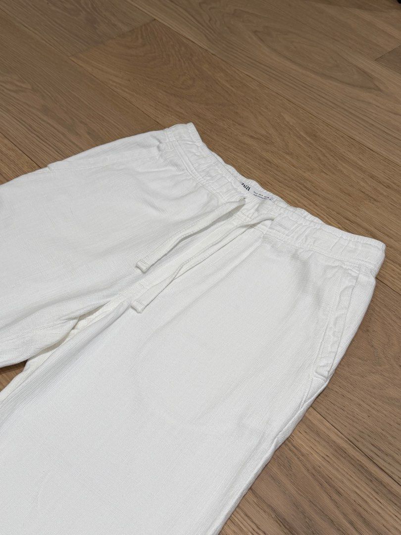 Zara: 100% Cotton Textured White Pants (Category: Trousers) located in Quezon City. Submitted by joes3 (Listing ID 1463338931, Image 2). Description: Zara: 100% Cotton Textured White Pants Color: White Size: Small Details: - Has elastic Waistband - Textured cotton Fabric - has Drawstring - Looks like Linen Pants Measurements: Length: 37-37.5” Waist: 15” (can expand to +.5 inches due to elastic waistband) Great Condition— no issues.