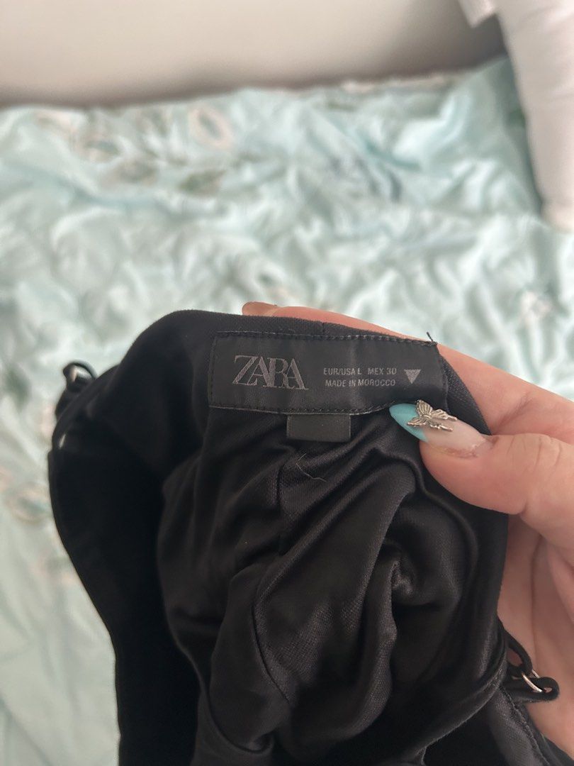 Zara Black Corset Style Button Front Peplum Top (Category: Sleeveless) located in Manila. Submitted by sophiaa_l (Listing ID 1463330474, Image 2). Description: - Black Zara top - Corset-style bodice - Button-front closure - Peplum hem - Adjustable spaghetti straps - Versatile: pairs well with jeans or skirts - Made in Morocco - it’s a little bit dented sa bottoms but I think if you iron it it’ll be fine. - straps are a bit uneven but adjustable .