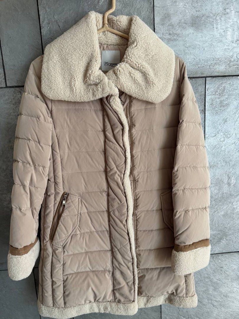 ZOOC Beige Puffer Jacket with Sherpa Collar (Category: Coats, Jackets and Outerwear) located in Taguig. Submitted by anxmz (Listing ID 1463404686, Image 1). Description: - Cozy beige puffer jacket from ZOOC - Features a warm sherpa collar and trim - Zipper closure with convenient pockets - Ideal for cooler weather, offering comfort and style.