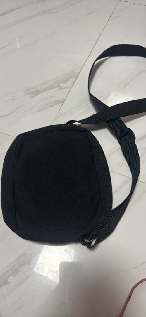 2027 Champion Black Crossbody Bag (Category: Cross-body Bags) located in Silang. Submitted by sari2bilina (Listing ID 1463667725, Image 3). Description: - Authentic Champion crossbody bag - Ideal for everyday essentials - Main zippered compartment for secure storage - Inner pocket for organization - Adjustable strap for a comfortable fit - Compact size: approximately 8" wide, 5" tall, and 2" deep.