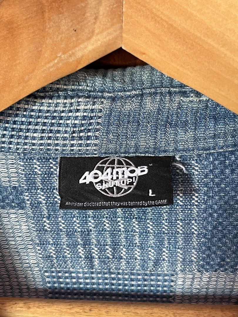 404MOB Button-Up Denim Long Sleeve Shirt Size L (Category: Tshirts & Polo Shirts ) located in Iriga City. Submitted by kjgonzales_ (Listing ID 1463582006, Image 2). Description: - Brand: 404MOB - Style: Button-up shirt - Graphic Print: Features 'Shut Up!' slogan and globe logo - Design: Unique all-over pattern - Pockets: Two chest pockets - Size: L - Occasion: Great for casual wear.
