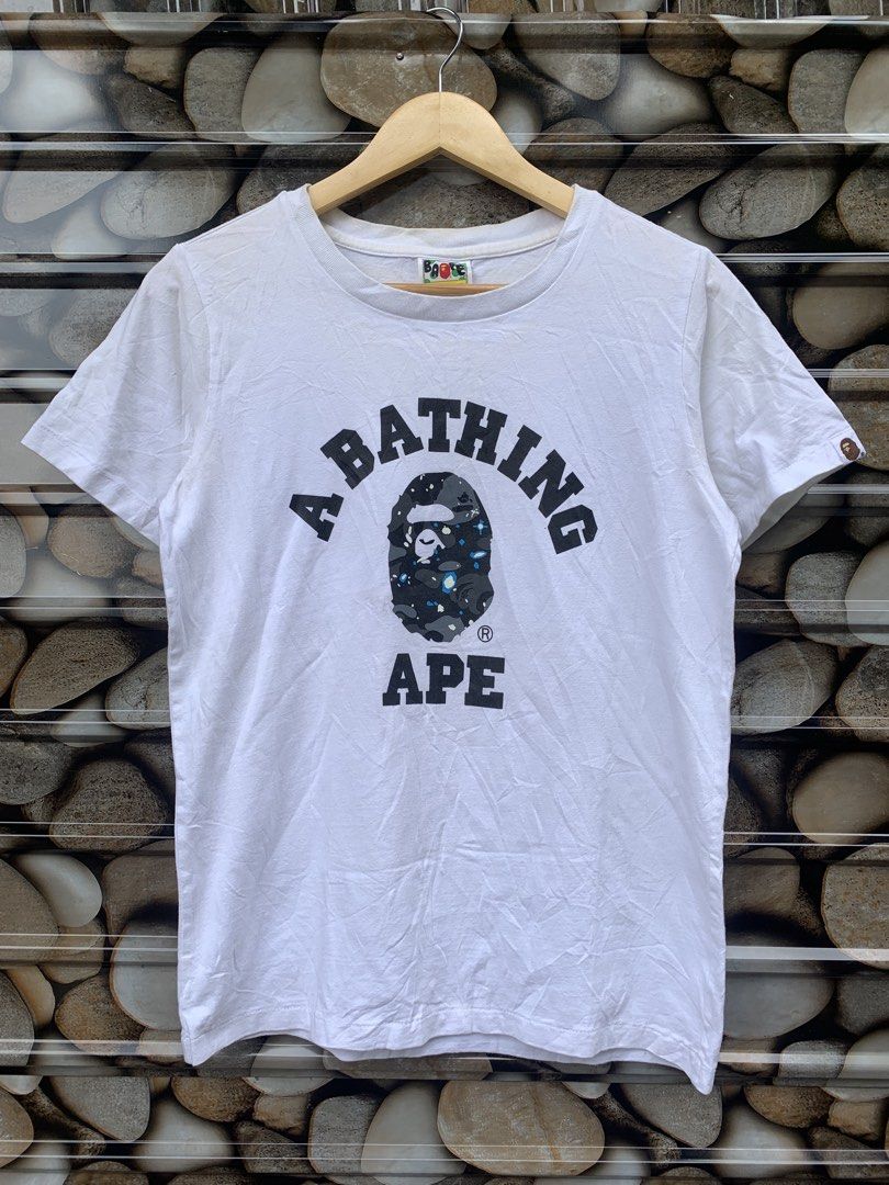 A Bathing Ape Ladies Tee Size S White BAPE (Category: Shirts) located in Aloran. Submitted by chester78864 (Listing ID 1463657870, Image 1). Description: - Authentic White A Bathing Ape (BAPE) T- -with sign of use. minir stain and need wash Shirt - Features the classic BAPE ape head logo with a camouflage pattern - Ladies Size S - Ideal for any BAPE enthusiast - Please check photos for detailed condition.