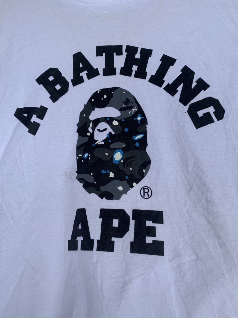 A Bathing Ape Ladies Tee Size S White BAPE (Category: Shirts) located in Aloran. Submitted by chester78864 (Listing ID 1463657870, Image 2). Description: - Authentic White A Bathing Ape (BAPE) T- -with sign of use. minir stain and need wash Shirt - Features the classic BAPE ape head logo with a camouflage pattern - Ladies Size S - Ideal for any BAPE enthusiast - Please check photos for detailed condition.